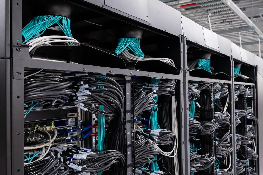 Wall of black computer chords with blue wiring