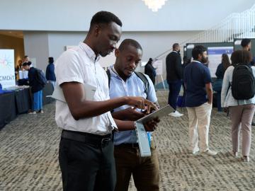 ORNL computing staff members Hector Suarez (middle) and William Castillo (right) talk HPC at the Tapia Conference career fair in San Diego, California. Credit: ORNL, U.S. Dept of Energy