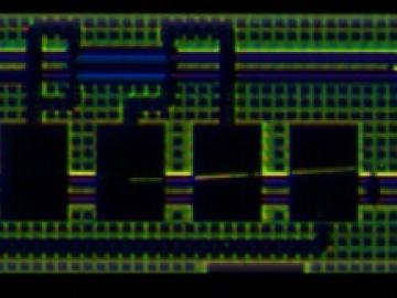 This is an image of a photon chip, it's a black background with green squiggle lines across it, with two blue lines running horizontally in the middle with an inch in between.